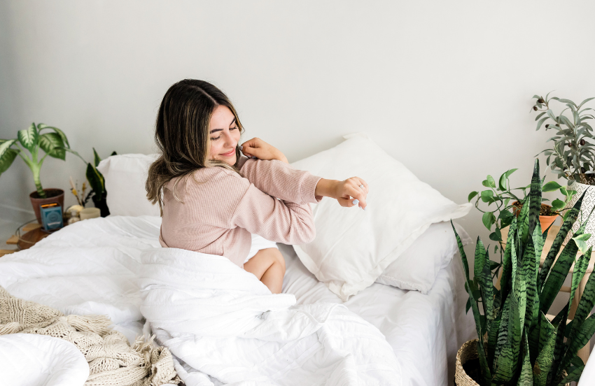 Healthy lady waking up in bed