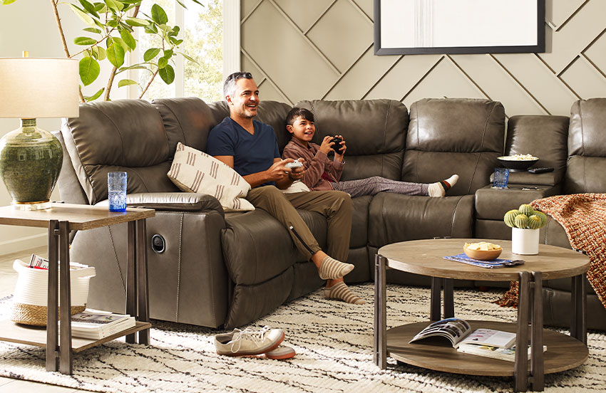 Father with son on leather sectional sofa