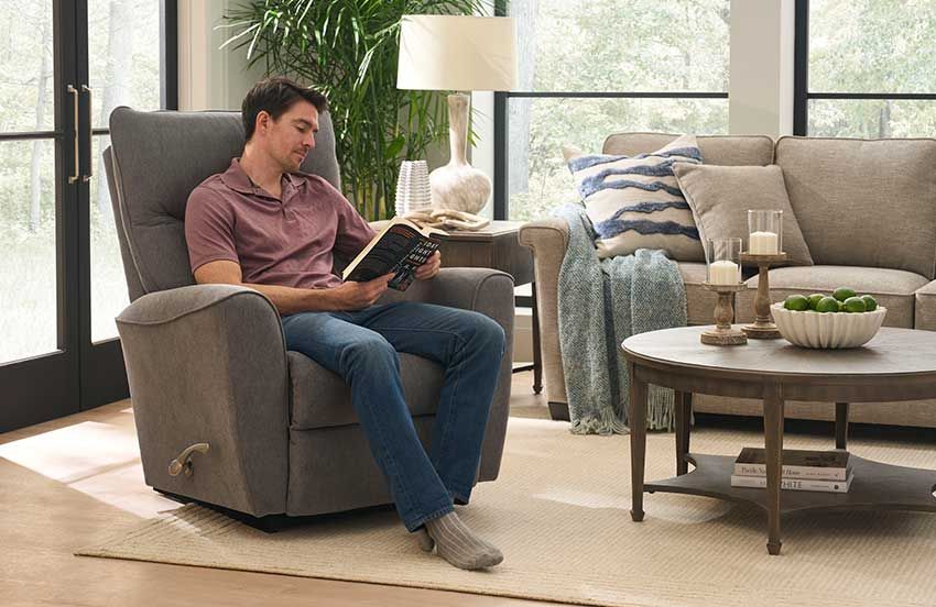 Man reading book in living room