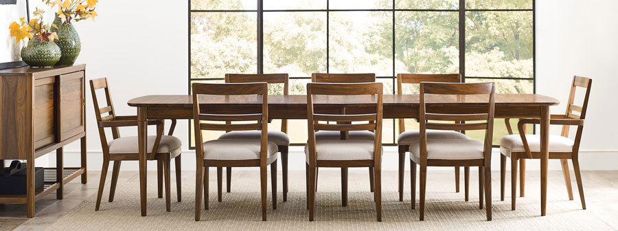 Dining room scene featuring a table with 8 chairs and sideboard.