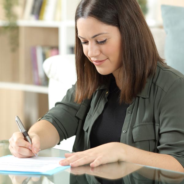 Woman filling out loan paperwork.